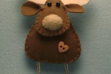 a deer Christmas ornament of felt with a heart button and mini buttons hanging is a very pretty and cozy idea to rock