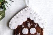 a pretty gingerbread house cookie ornament with embroidery and beads is a lovely and very cozy idea to rock