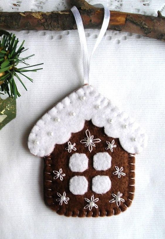 a pretty gingerbread house cookie ornament with embroidery and beads is a lovely and very cozy idea to rock