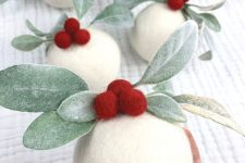 a white felt ball Christmas ornament with berries and leaves is a lovely and chic idea to enjoy