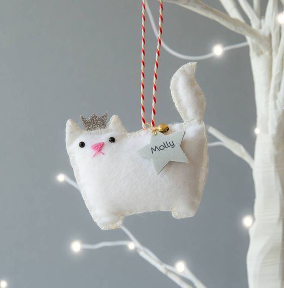 a white princess cat ornament of felt, with a bell and a star is a gorgeous personalize idea for Christmas