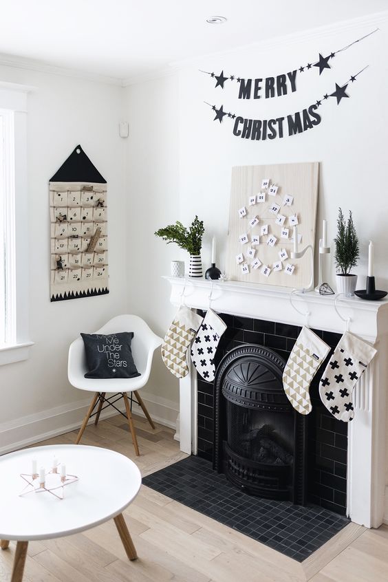 black and white stockings, black garlands, an advent calendar and black and white pillows