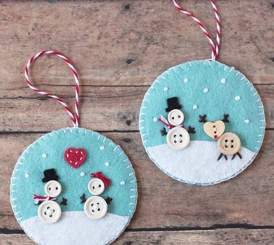 bright felt Christmas ornaments of blue and white felt, with buttons showing off fun Christmas scenes are amazing