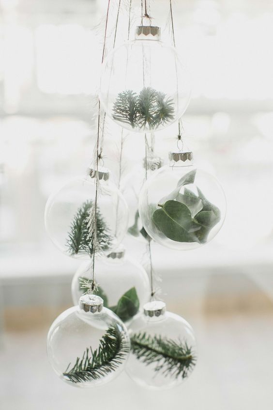 clear glass ornaments with greenery and evergreens hung in a cluster for a natural feel