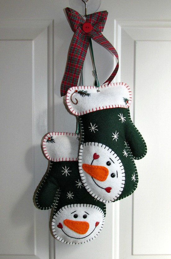 green and white felt Christmas mittens with colorful embroidery and beads are cool not only for tree decor but also for front doors