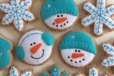turquoise and white ginger bread cookie Christmas ornaments shaped as snowmen heads and snowflakes are amazing