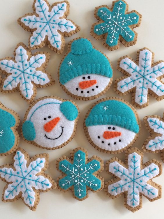 turquoise and white ginger bread cookie Christmas ornaments shaped as snowmen heads and snowflakes are amazing