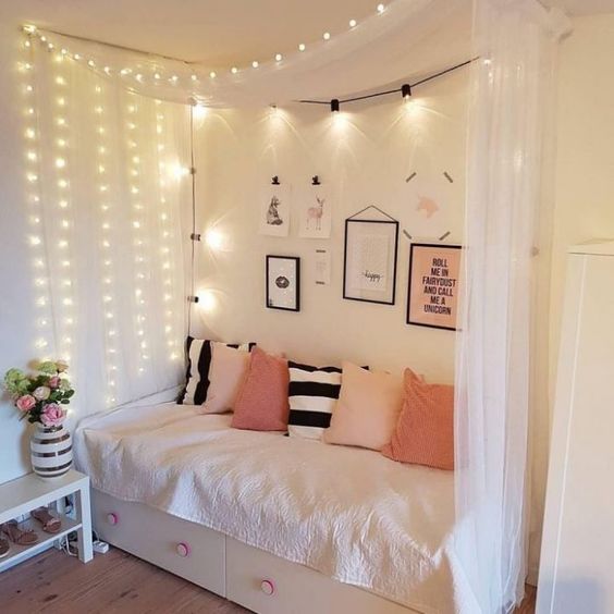 a canopy with lighting on one side of the bed and over it, too