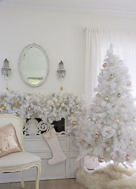 a refined vintage Christmas space with a white Christmas tree with gold and pink ornaments, a matching garland on the mantel, a white faux fur tree skirt