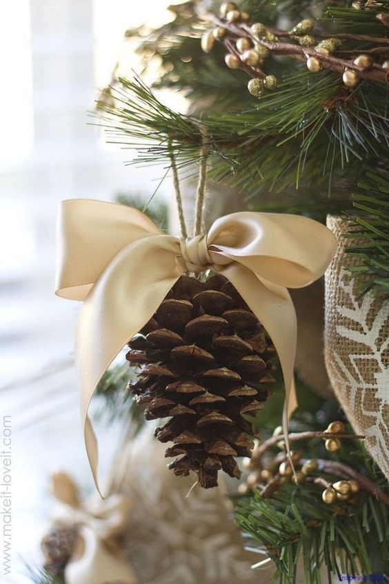 a rustic Christmas ornament of a pinecone with a large silk bow is an easy DIY