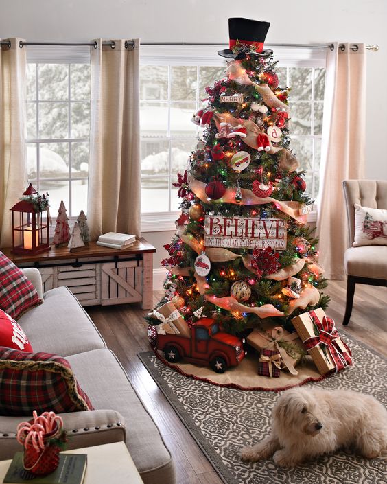 a rustic vintage Christmas tree withburlap ribbons, colorful lights, a hat on top, a toytruck and gift boxes