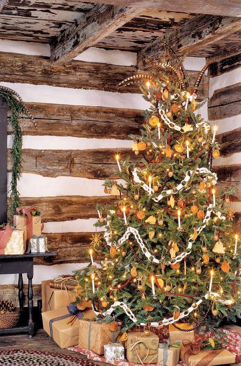 a vintage Christmas tree decorated with lights, citrus slices, stars, cranberry garlands, paper chains and other stuff