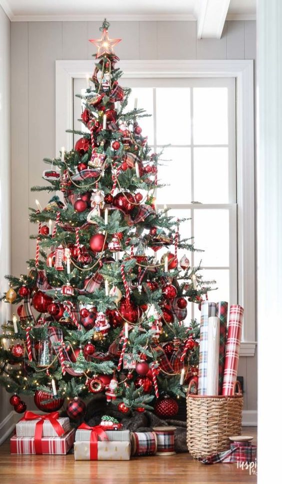 a vintage-inspired Christmas tree with red ornaments, lights and candy candes looks bold and catchy