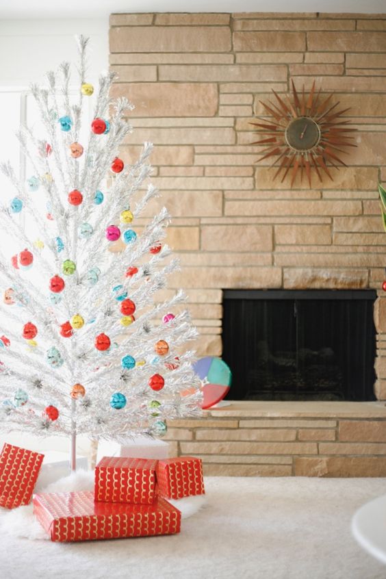 a white Christmas tree with lots of colorful Christmas ornaments looks pretty, chic and vintage