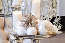 elegant vintage Christmas decor with a silver stand with white ornaments, glass candleholders, a beaded tree and mercury glass touches