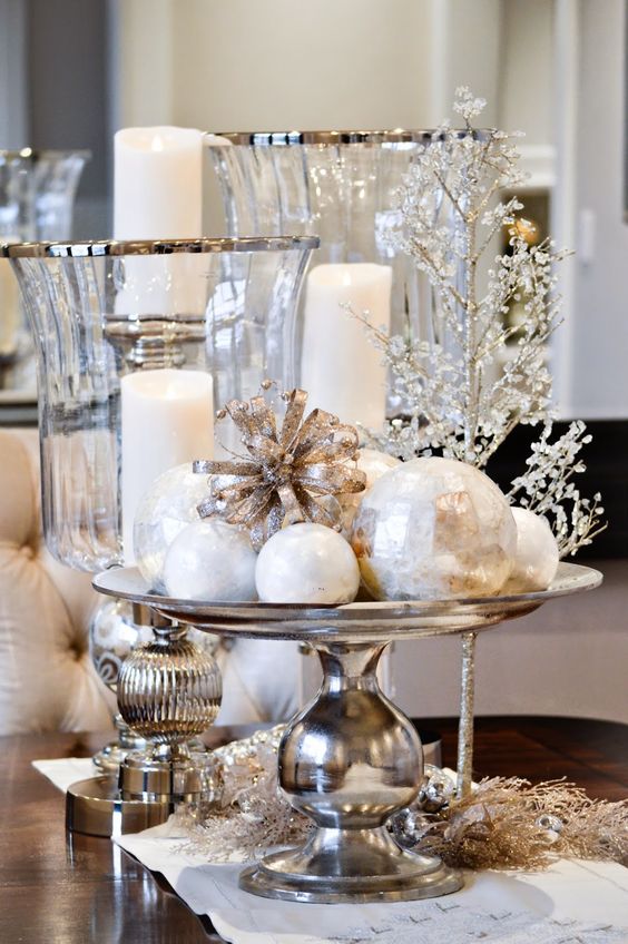 elegant vintage Christmas decor with a silver stand with white ornaments, glass candleholders, a beaded tree and mercury glass touches
