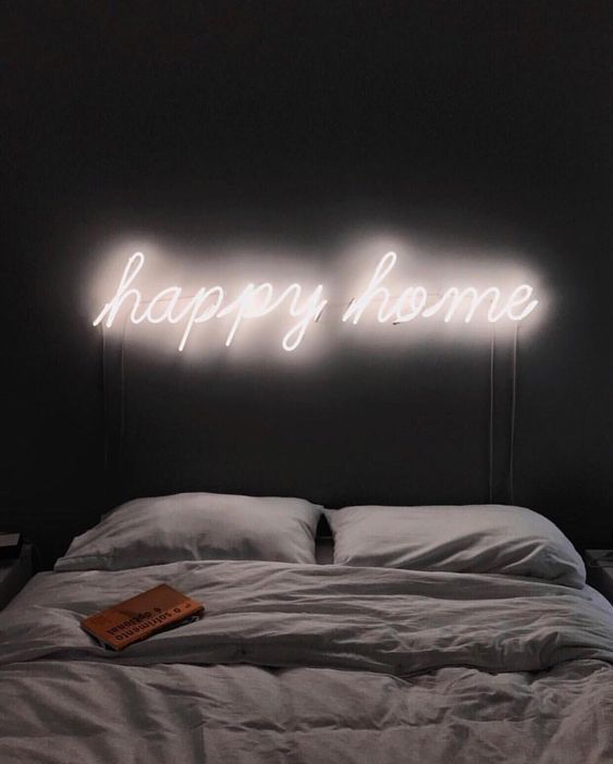 neon lights over the bed is a cool idea to light up the space in a modenr and stylish way