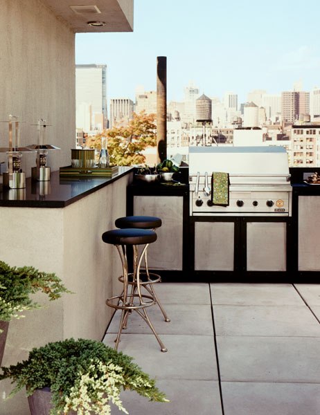 An outdoor kitchen is a perfect thing to have on a terrace if you like to grill steaks by yourself.