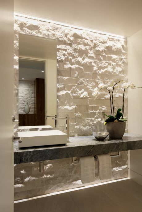 an accent wall done with white decorative stone is a chic idea for a contemporary space