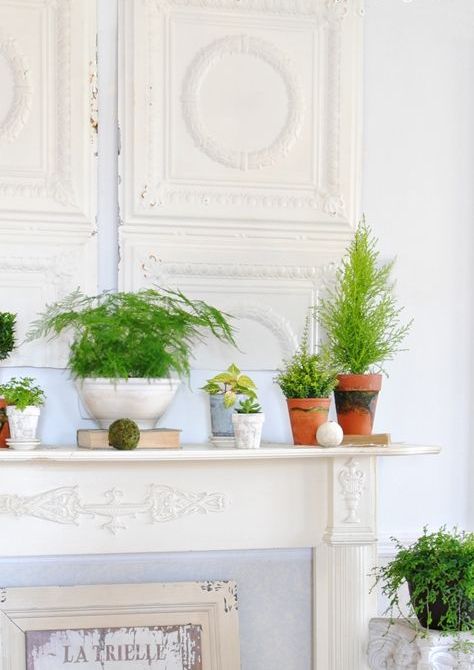 a botanical look with potted greenery, moss and wooden balls is simple stylish with vintage chic