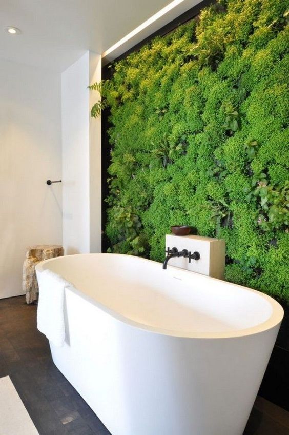 a contemporary bathroom in neutrals with a living wall that takes over the whole space at once