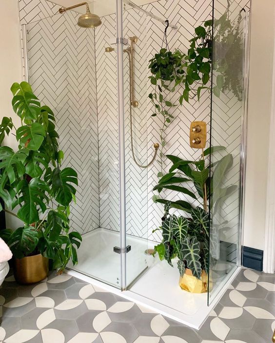 a contemporary bathroom with potted plants on the floor and suspended in the shower space
