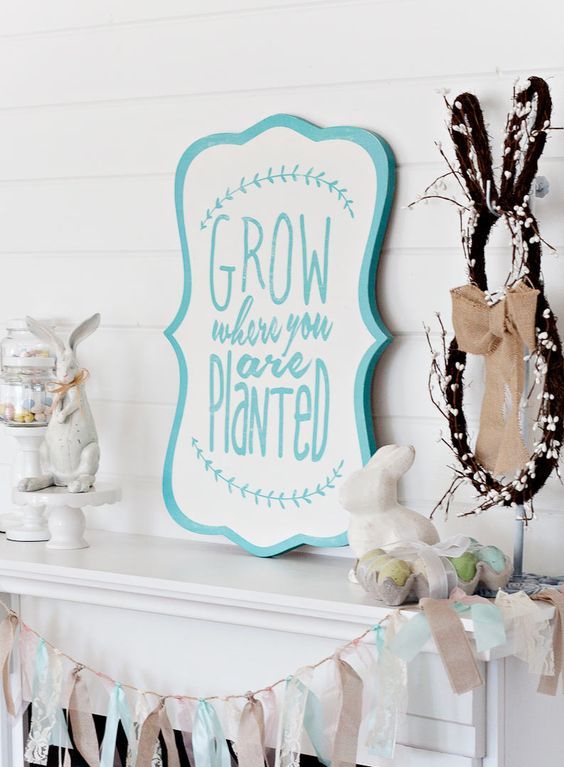 a cute vintage-inspired Easter mantel with bunny figurines, a tassel bunting, a sign and some fake eggs