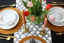 a fish scale runner, pink candles, a bright tulips centerpiece, wicker chargers and printed napkins