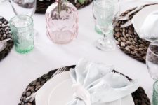 a neutral spring tablescape with pastel glasses and blooms is added drama with dark wicker chargers