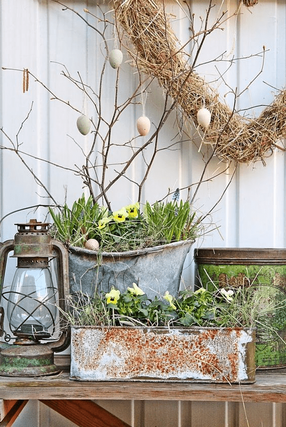 chic front Porch Easter decor with an Easter egg tree, potted blooms and a vintage lantern