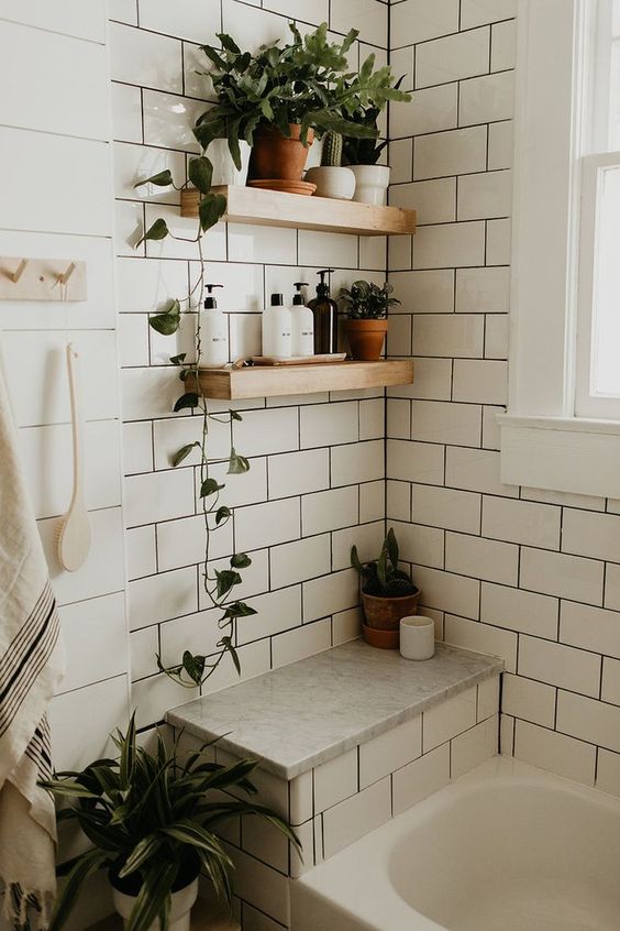 place some greenery in pots on the open shelves to make your neutral bathroom feel and look very fresh