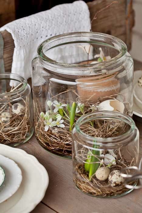 rustic Easter decor with jars with vine, greenery, blooms and speckled eggs is a cool idea for spring