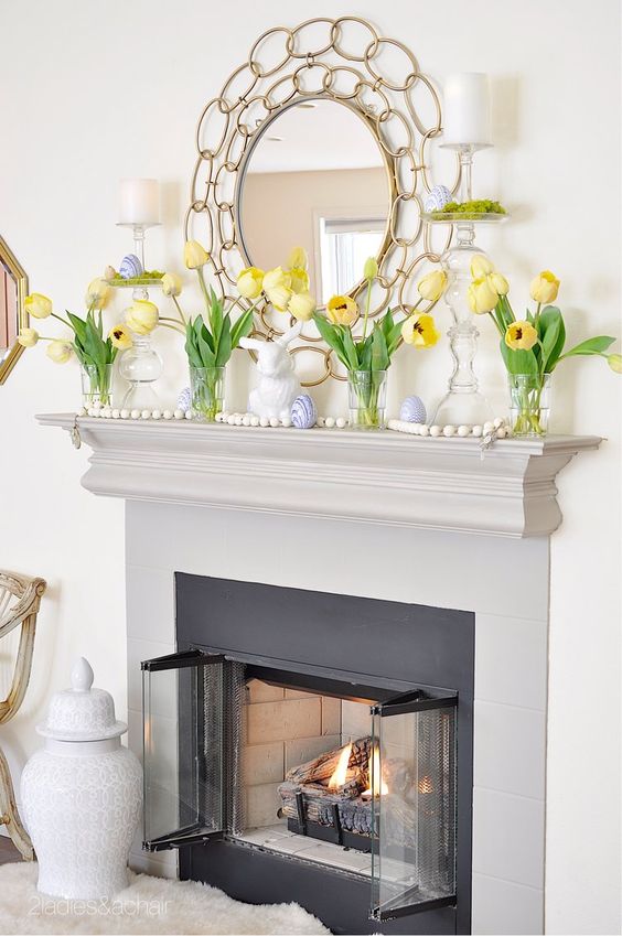 simple Easter mantel styling with yellow tulips, wooden ebads and fake blue eggs and a bunny