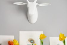 some faux speckled eggs, bright yellow tulip arrangements and egg artworks for an Easter mantel
