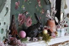 vintage spring mantel decor with a tray with art, some faux blooms and greenery, fake eggs and tableware