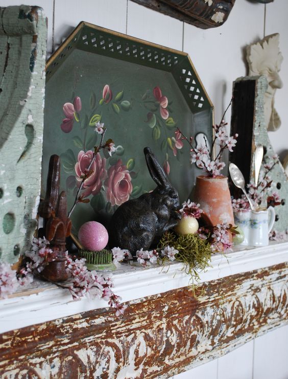 vintage spring mantel decor with a tray with art, some faux blooms and greenery, fake eggs and tableware