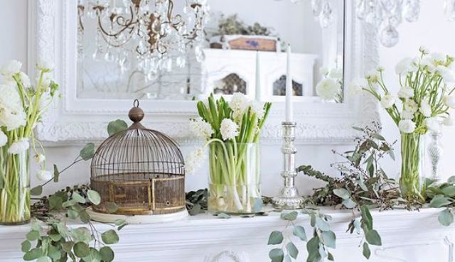 white bloom arrangements in clear vases, bird cages, fresh greenery and elegant candles