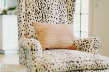 a Dolmatin printed chair with a peachy pillow is a catchy and stylish accent to the space, it’s a bold and pretty idea