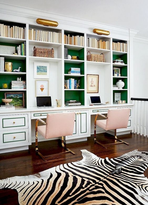 a brigth green wall and pink chairs plus gold touches add fun and brightness to the home office