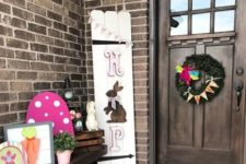 a colorful Easter porch with some themed artworks, a greneery wreath and a HOP and bunny sign