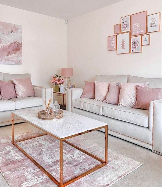 a delicate and lovely girlish living room with neutral seating furniture, pink pillows, a pink gallery wall, a coffee table and a pink rug