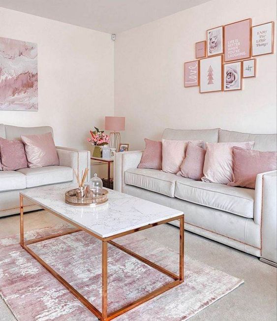 a delicate and lovely girlish living room with neutral seating furniture, pink pillows, a pink gallery wall, a coffee table and a pink rug