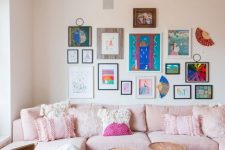 a feminine living room with neutral walls, a light pink sofa with fringe pillows, a colorful gallery wall, Moroccan stools and a pink rug