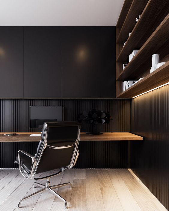 a minimalist masculine home office  with an open shelving unit with lights, a floating desk, sleek black cabinets for storage