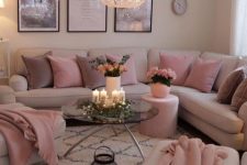 a modern girlish space with neutral walls, a neutral corner sofa and matching chairs, mauve and pink pillows and blankets and candle lanterns plus a gorgeous chandelier