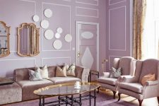 a sophisticated lilac living room with lilac walls and a ceiling, neutral seating furniture, a glass coffee table and a vintage chandelier
