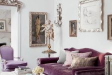 a sophisticated living room with a purple sofa and a lilac chair, a creamy ottoman, a crystal chandelier, beautiful and refined artworks