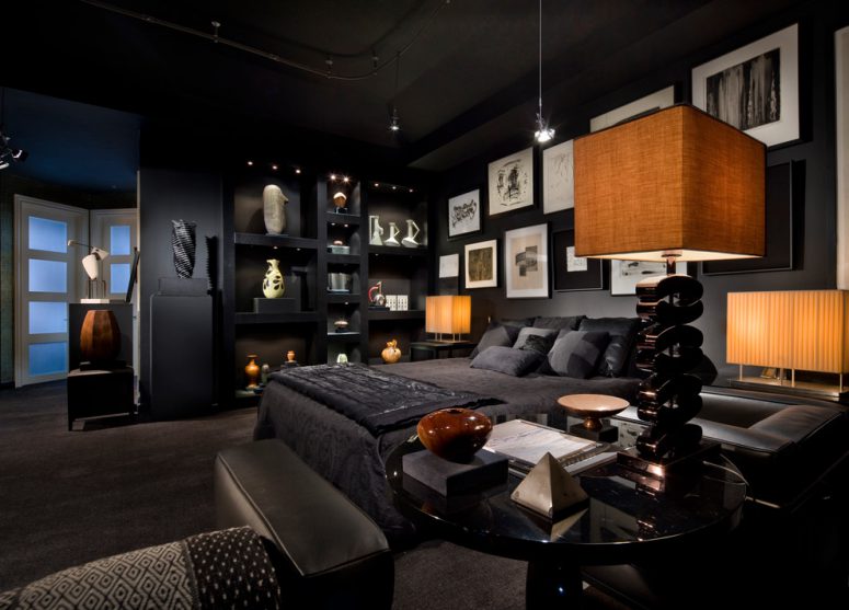 all black bedroom with an interesting art wall and very thoughtful lighting