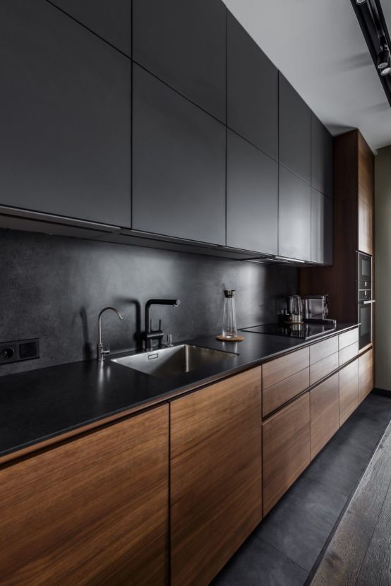 an ultra-minimalist kitchen with sleek black and rich-stained cabinets plus a sleek countertop plus a stone backsplash