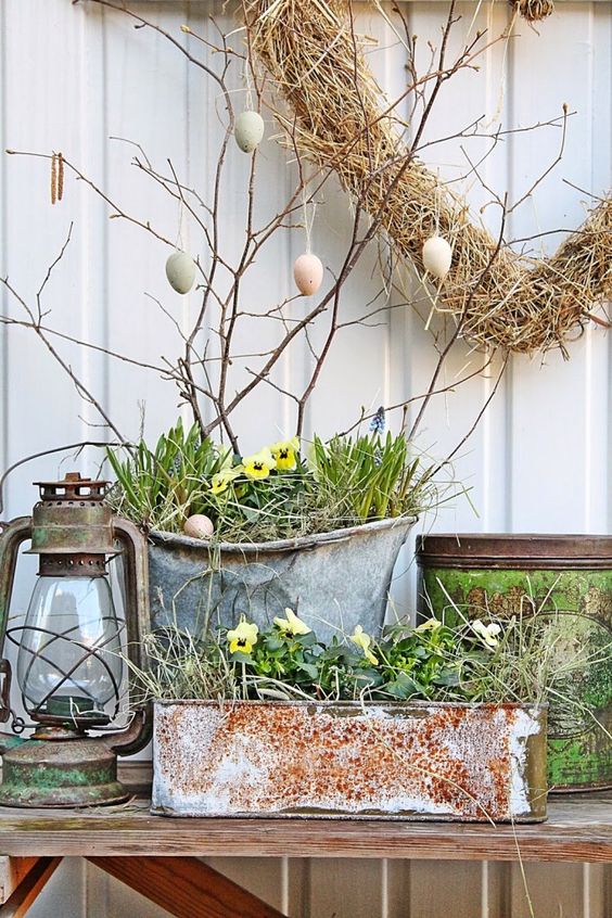 chic front Porch Easter decor with an Easter egg tree, potted blooms and a vintage lantern